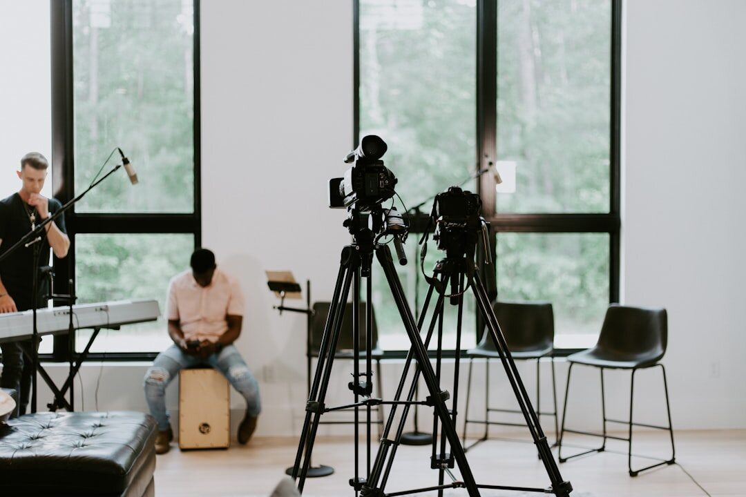 Group of journalists reviewing interview footage on screens